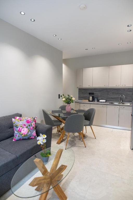 a living room with a couch and a table and a kitchen at KLELIA Luxury Apartment in Alexandroupoli