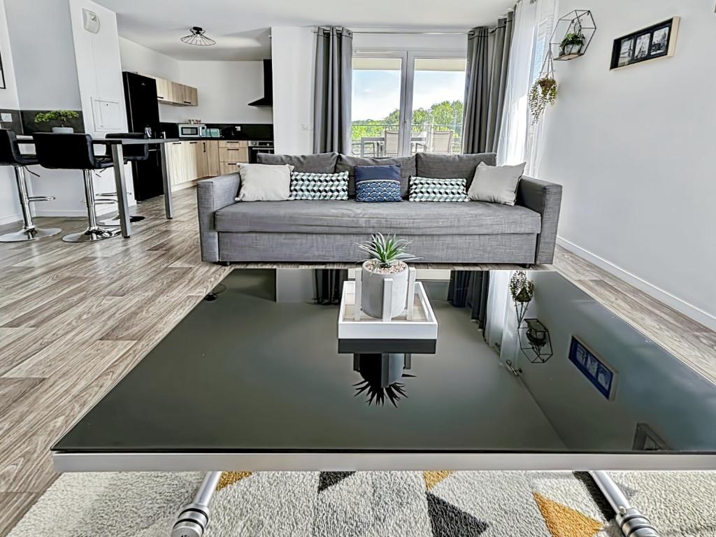 a living room with a couch and a table at Lovely Apartment Disneyland Paris - Rentaway BnB in Montévrain