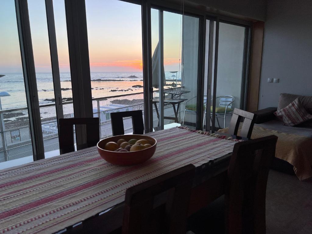 a bowl of fruit on a table with a view of the beach at Perfect Sea View in Vila do Conde