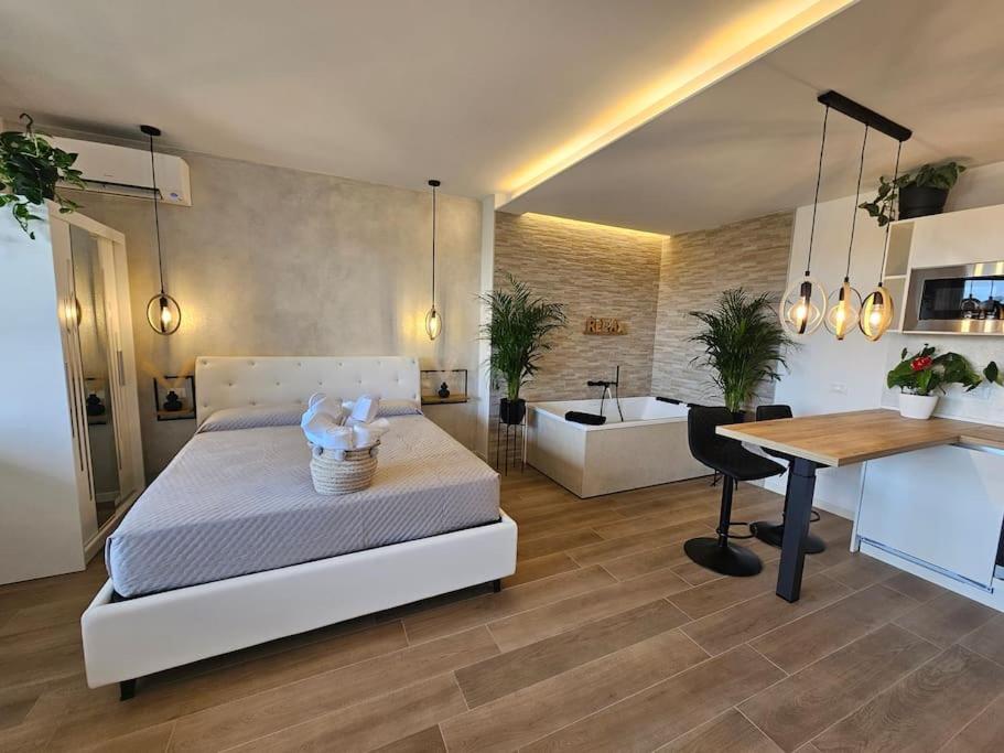 a bedroom with a bed and a desk and a table at Luxury Suite, Villa Joy Verona , Exclusive Romantic Luxury Suite with Jacuzzi, near Verona Center in Verona