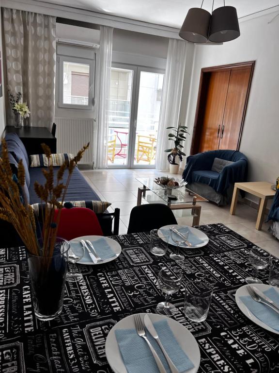 a living room with a table with plates on it at Central Stylish Apartment in Thessaloniki