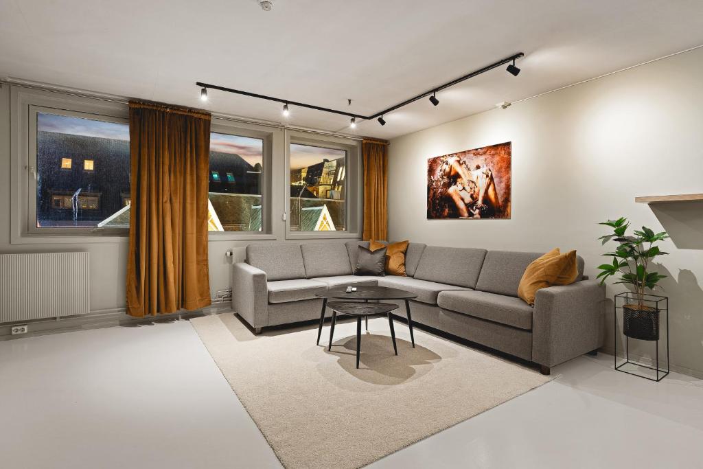 a living room with a couch and a table at Arctic Homes - ALL APARTMENTS in Tromsø