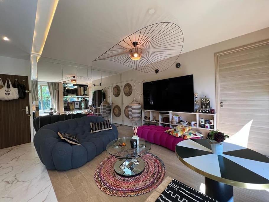 - un salon avec deux canapés bleus et une télévision dans l'établissement Unique and Central I Garden in City Center, à Boulogne-Billancourt