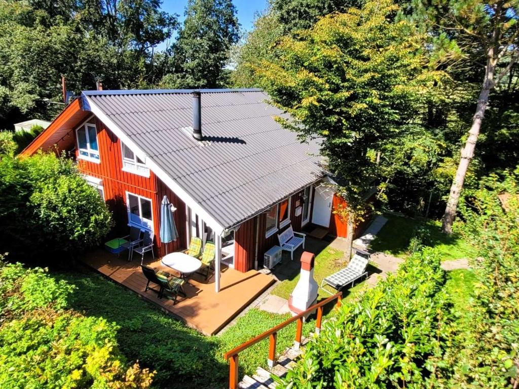 an overhead view of a red house with a porch at Gemütliches Ferienhaus für 5 Personen mit Sauna und Kaminofen und Grill im Ferienpark Extertal in Extertal