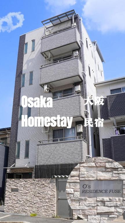 a building with a sign on the side of it at F HOUSE Os Residence S3 in Osaka