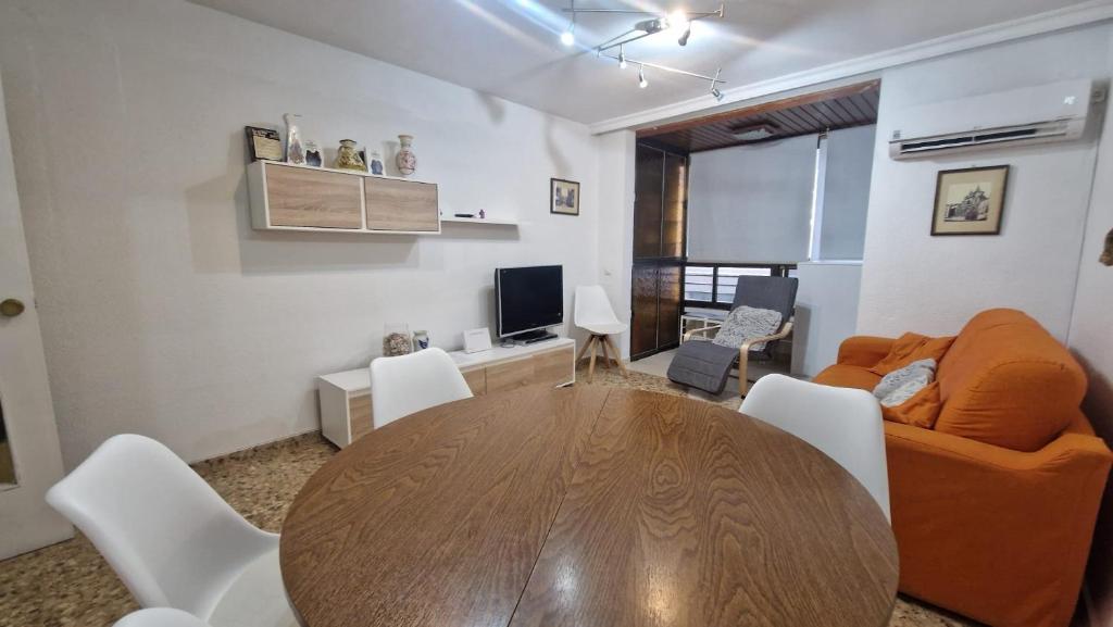 a living room with a wooden table and a couch at La Explanada in Alicante