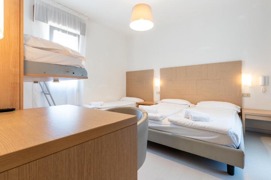 Postel nebo postele na pokoji v ubytování Hotel Regina
