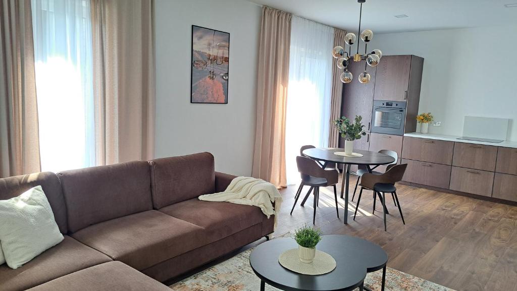 a living room with a couch and a table at Jankaus apartamentai in Šilutė