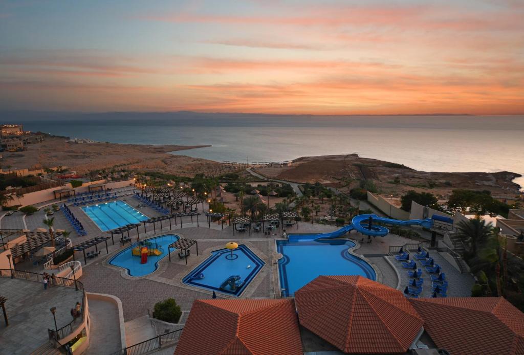 an aerial view of a resort with two pools at Dead Sea Spa Hotel in Sowayma