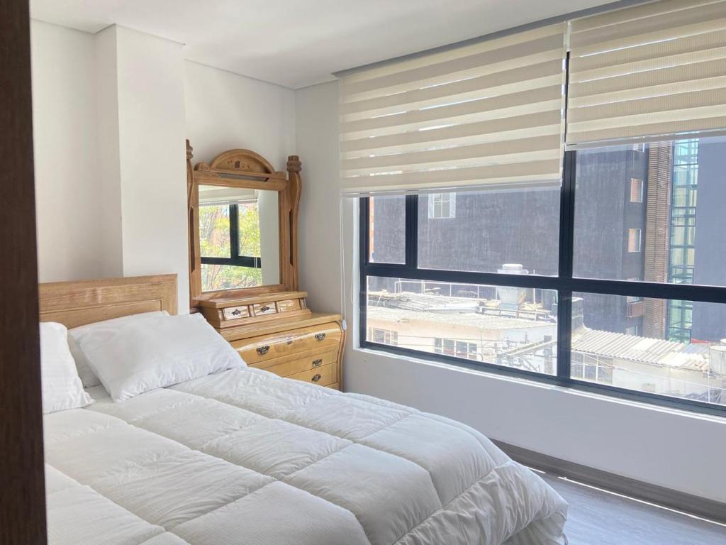 Ένα ή περισσότερα κρεβάτια σε δωμάτιο στο Elite Home Apartamentos