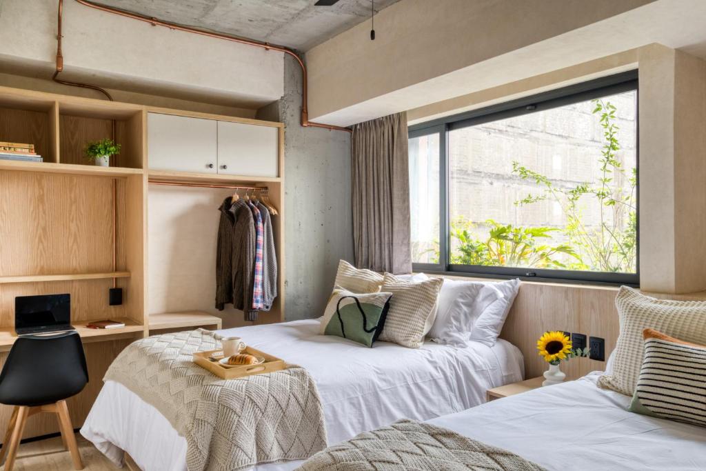 Postel nebo postele na pokoji v ubytování Caliza Roma Residences by Tasman