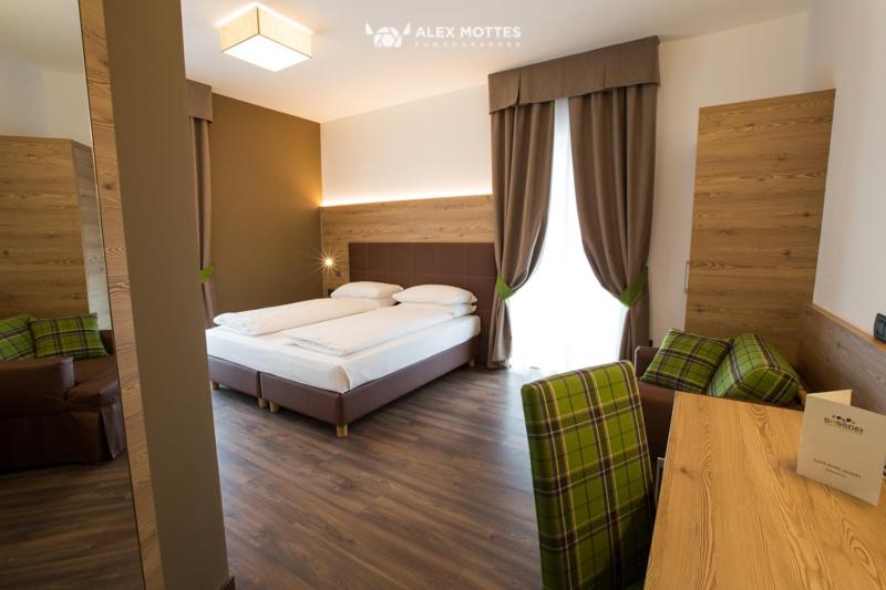 Postel nebo postele na pokoji v ubytování Sassdei My Active Suite Hotel