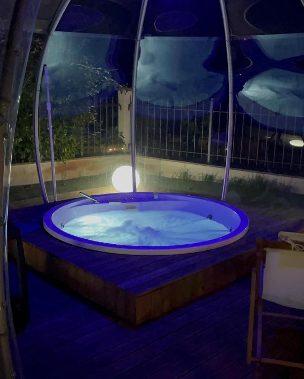 a jacuzzi tub on a deck at night at VILLA PATTY ASSISI con SPA e Piscina in Assisi
