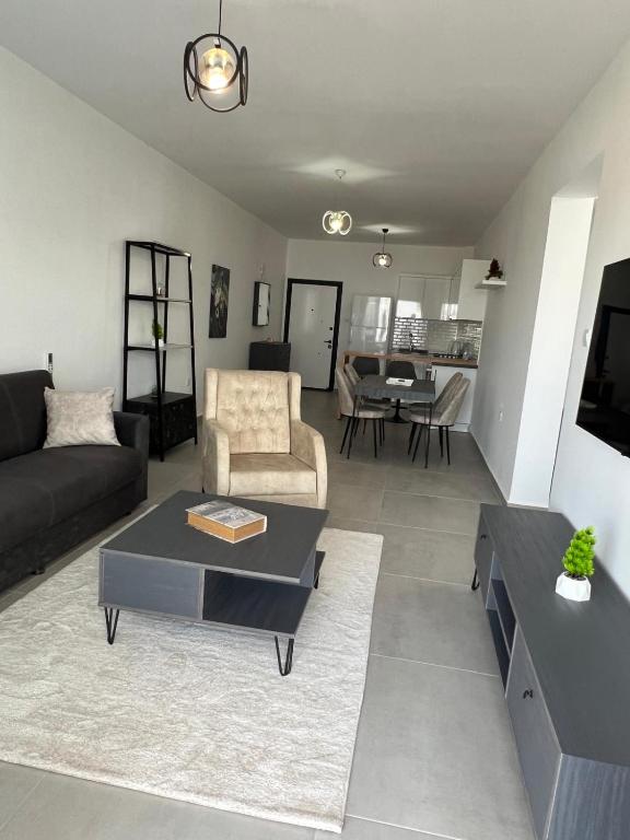 a living room with a couch and a table at Caesar Resort Didious in Iskele
