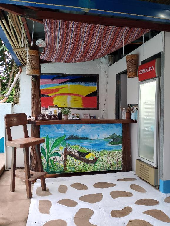 a painting on the wall of a room with a chair at Casa Montemar Heights in Coron