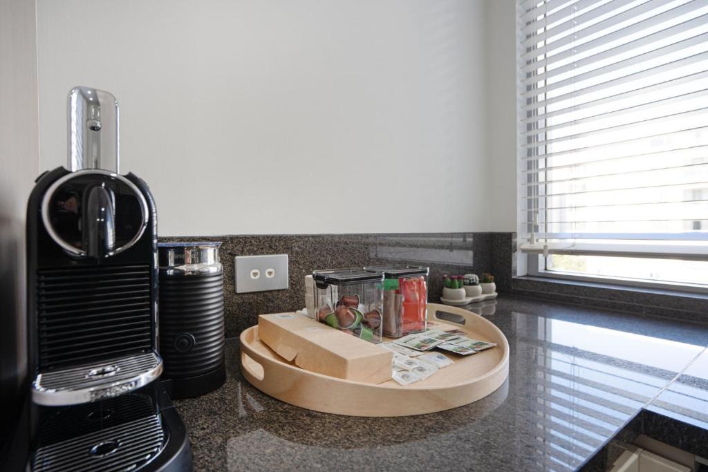 a kitchen counter with a box of food and a blender at Modern 1-Bed Unit with Pool Views and Balcony in Canberra