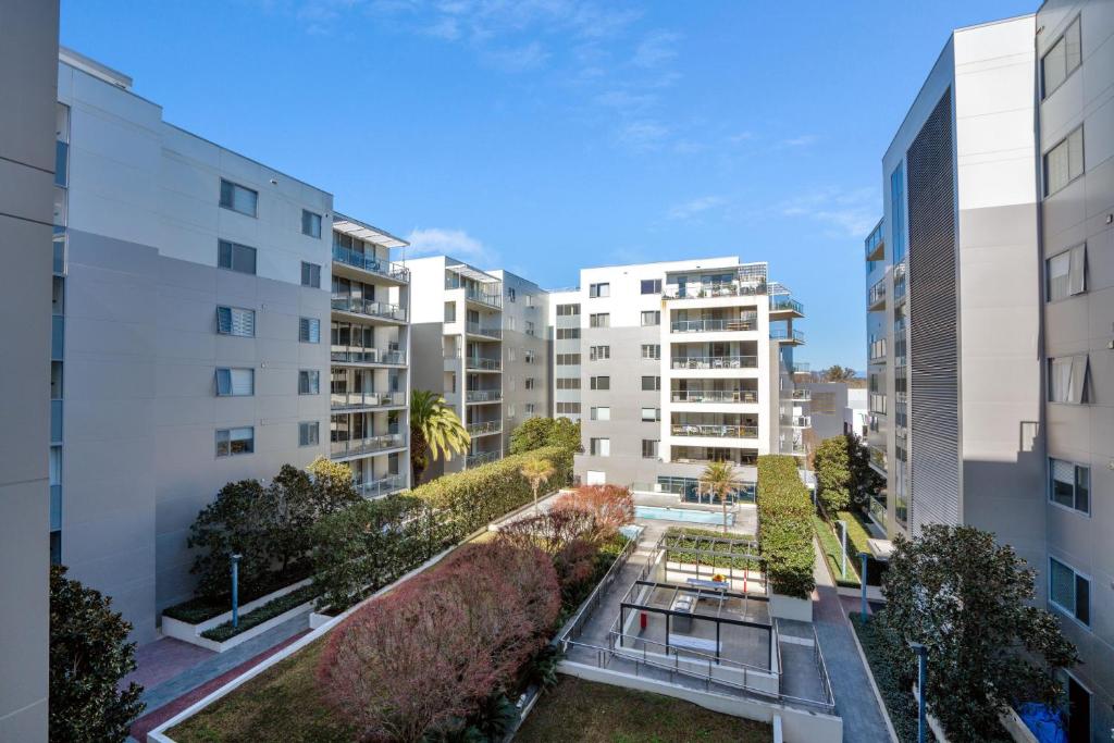 an aerial view of buildings in a city at Modern 1-Bed Unit with Pool Views and Balcony in Canberra