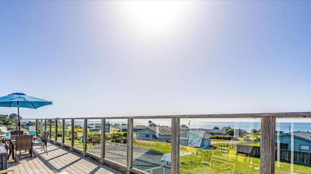 a balcony with a table and an umbrella at Bodega Bay Oasis A Wine Country Escape in Bodega Bay