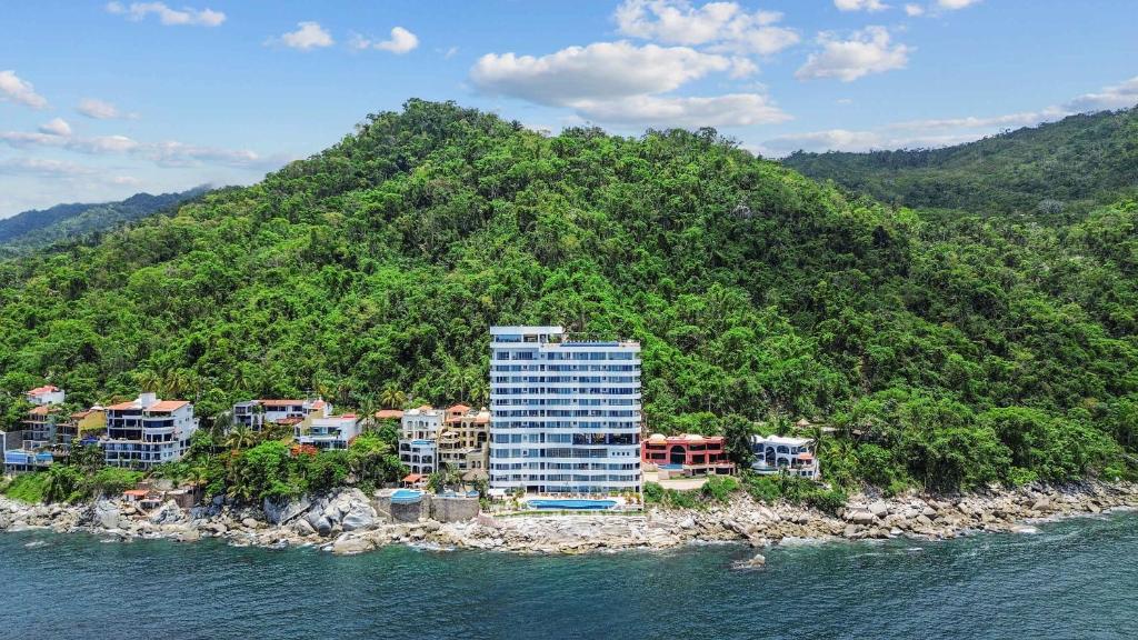 a building on an island in the water at Blue Horizon Luxury Condo in Puerto Vallarta