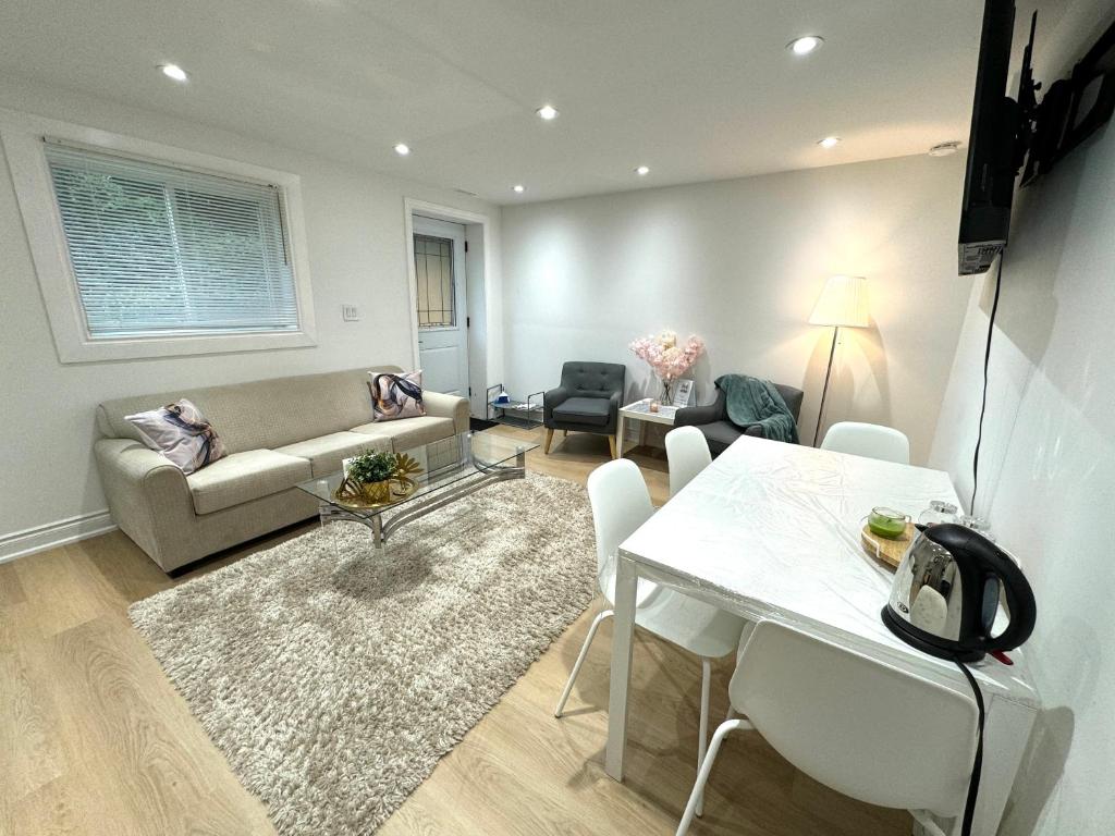 a living room with a couch and a table at Cozy, brand-new, 2BDR,walkout apt, free parking in Richmond Hill