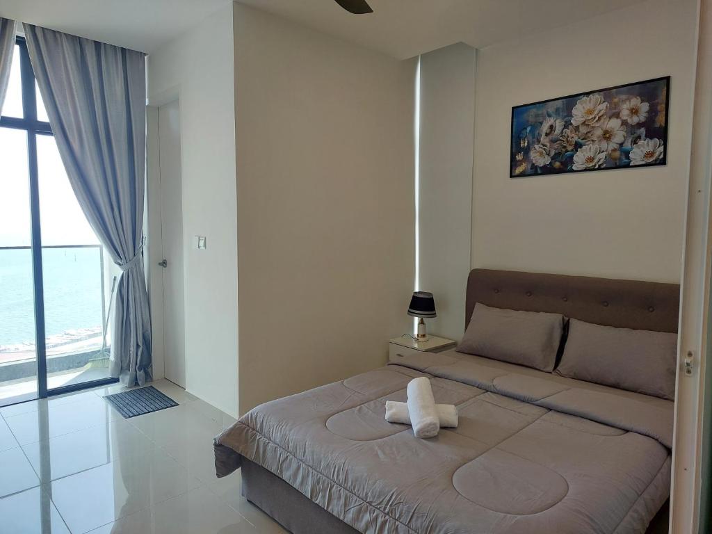 Postel nebo postele na pokoji v ubytování The Shore Kota Kinabalu City Centre By San's Suites