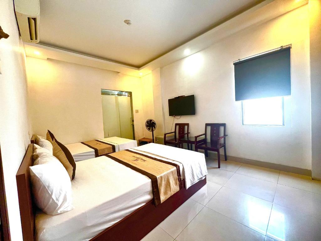 Postel nebo postele na pokoji v ubytování Danang Classic Hotel