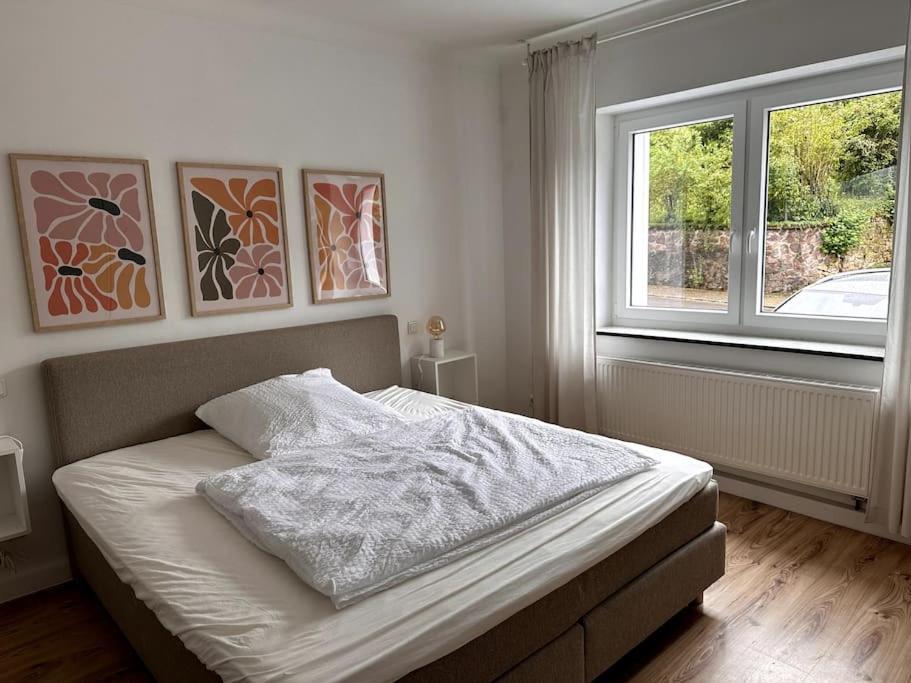 a bedroom with a bed and a window at Ferienhaus chez nous in Merzig