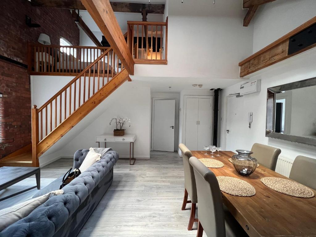 a living room with a table and a couch at Ranmoor Serviced Apartments at Victoria Quays in Sheffield