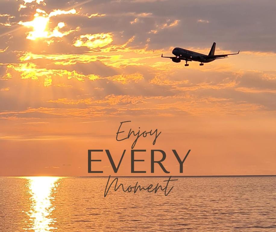 an airplane flying in the sky over the ocean at Panoramic Cozy Luxury Apt#15 Sea and Mountain Views Washing machine Bidet Wifi in Batumi