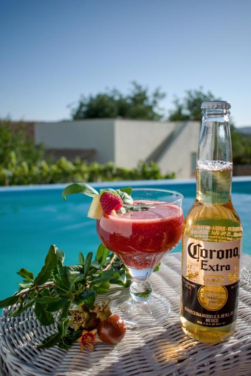 a drink on a table next to a bottle of alcohol at Villa Peral in Peral