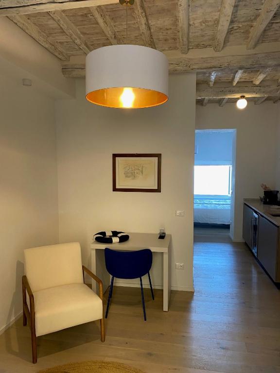 a living room with a table and a chair at Casa Cotone 5 in Marciana Marina