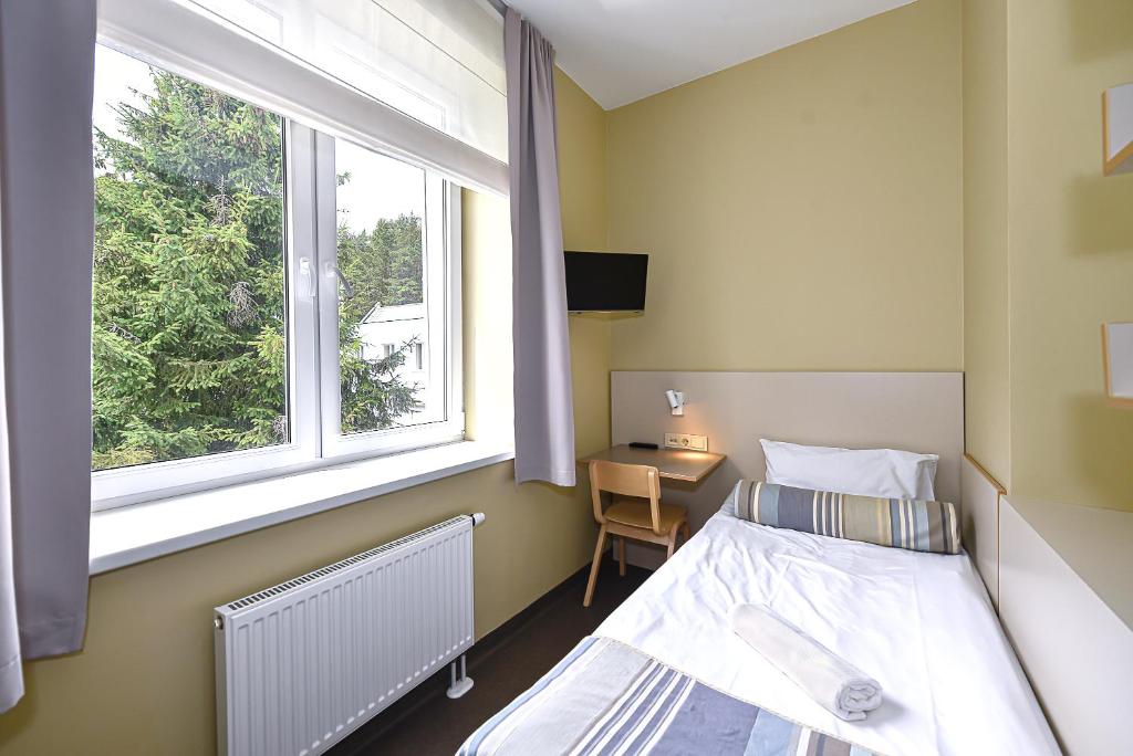 Postel nebo postele na pokoji v ubytování Nykščio Hostel