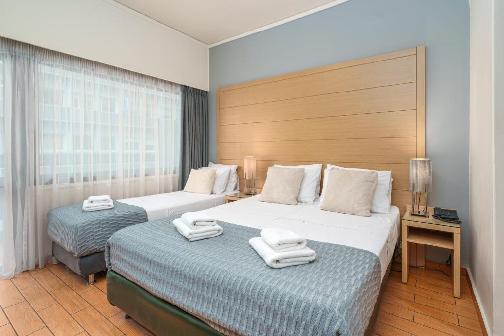 Posteľ alebo postele v izbe v ubytovaní Parnon Hotel