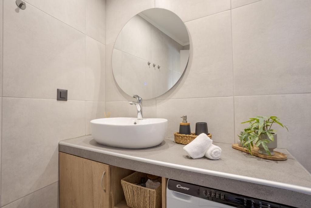 a bathroom with a sink and a mirror at Comfinest in Chania