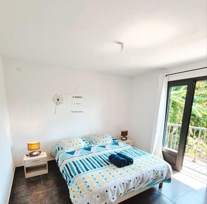 a bedroom with a bed and a window at O' Calme - Duplex - T3 - Piscine in Le Dioré