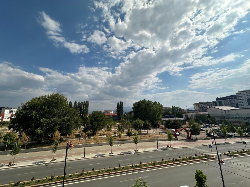 an empty street in a city under a cloudy sky at Welcome to my happy place in the center of Gjakova in Gjakove