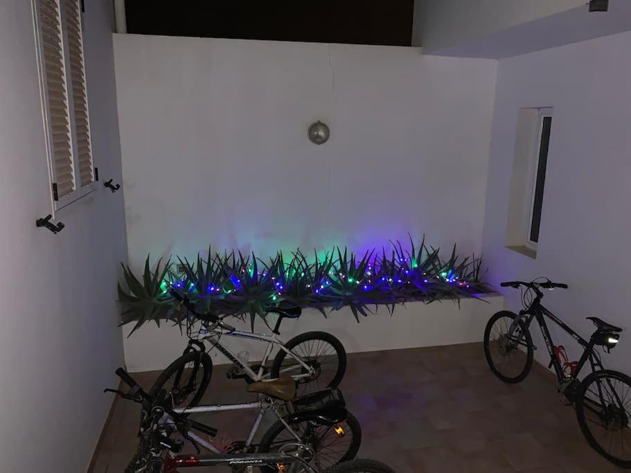 two bikes parked in a room with blue lights at Attico Surfhouse Mistral Estoril in Sal Rei