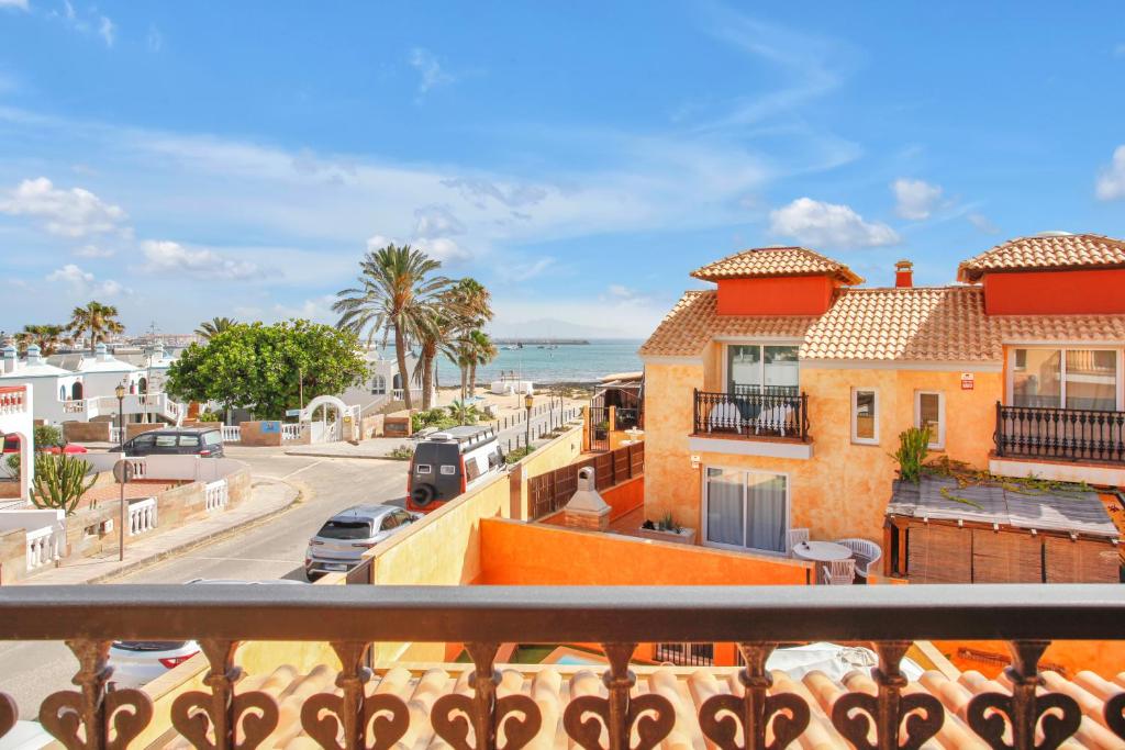 a balcony with a view of a street and the ocean at Amazing villa by the beach with private pool in Corralejo
