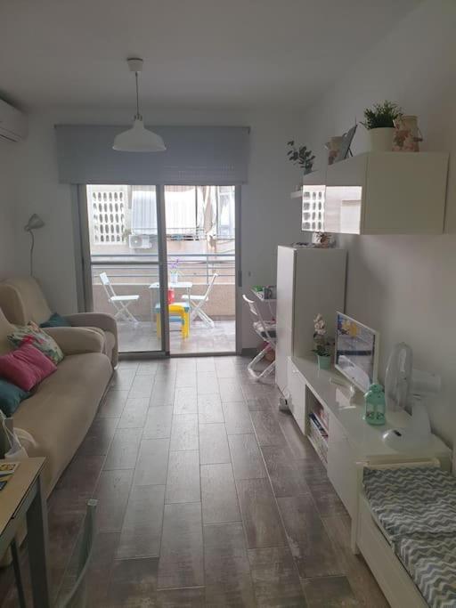 una sala de estar con un sofá y una mesa en piso playa, en Santa Pola