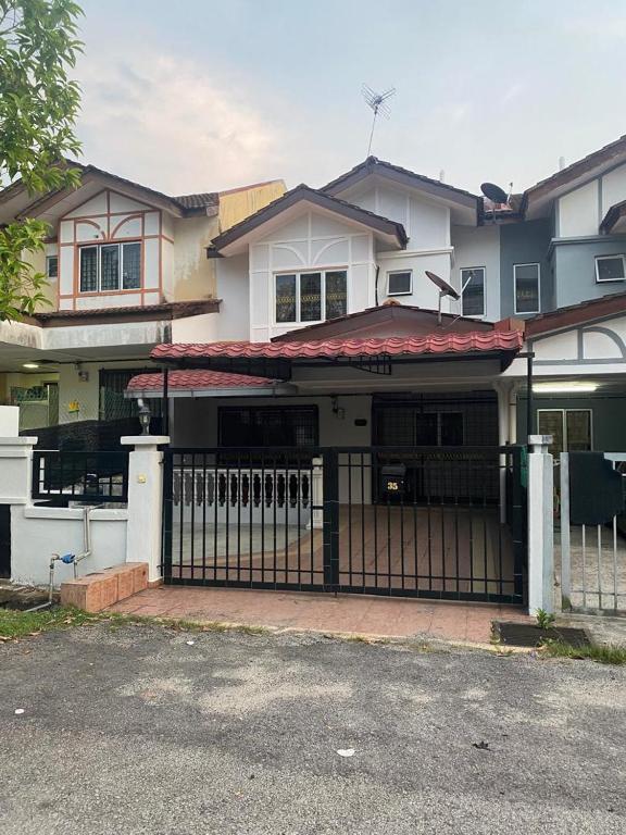 a house with a gate in front of it at Bangi in Kajang