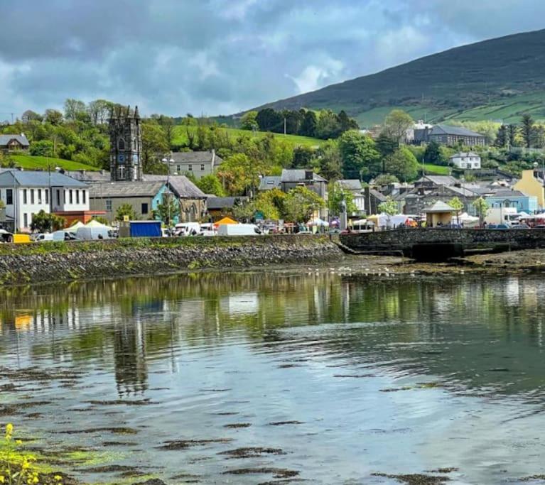 a body of water with a town in the background at Explore The Wild Atlantic Way in Bantry