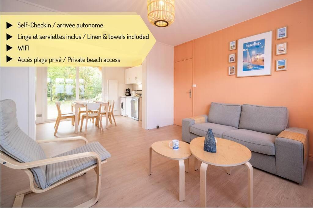 a living room with a couch and a table at La Rafale rez de chaussée - Accès Privée à la plage in Grand-Fort-Philippe