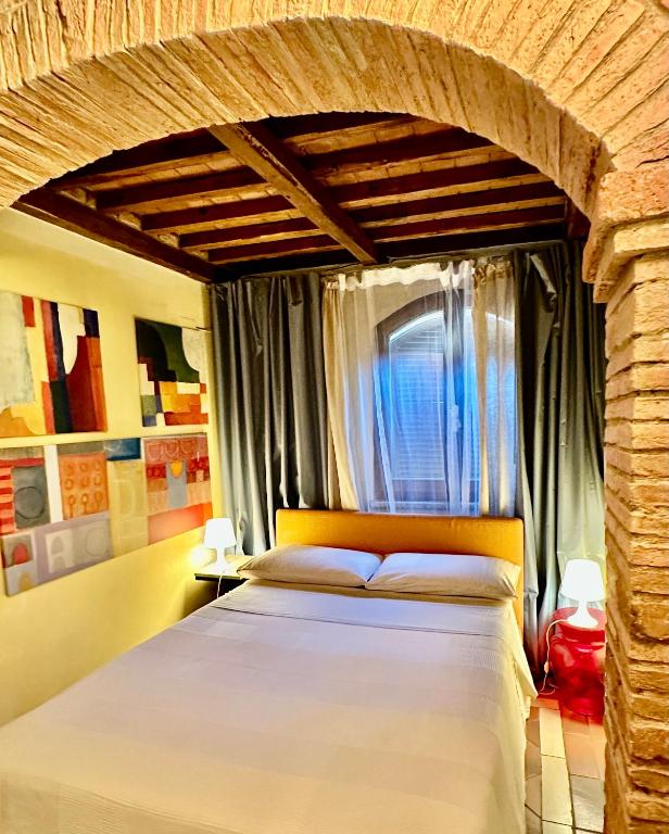a bedroom with a large bed in a room at The Small Sweet House in Montepulciano