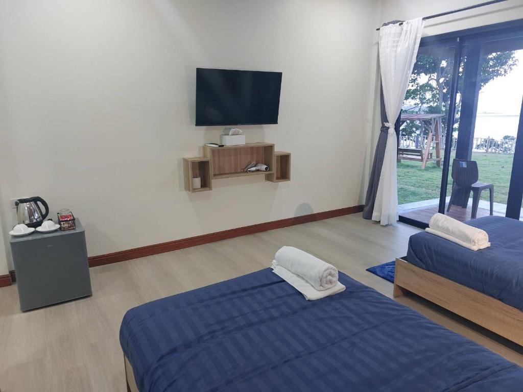 Postel nebo postele na pokoji v ubytování ลานแลเล รีสอร์ท ชุมพร Larn-Lae-Lay Resort Chumphon