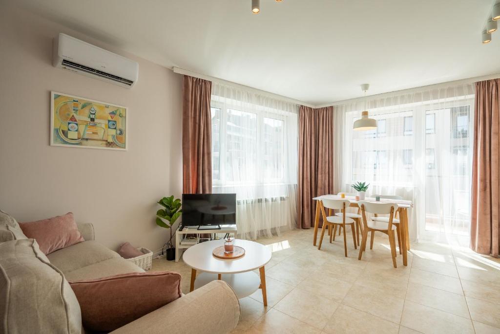 a living room with a couch and a table at Fusion Finesse in Sofia