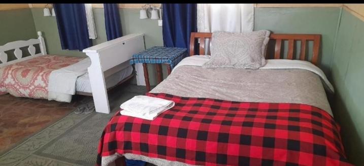 Postel nebo postele na pokoji v ubytování Giraff maasai mara home stay&safaris