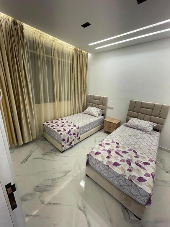 Postel nebo postele na pokoji v ubytování Oumaira Residence Azla-Tetouan
