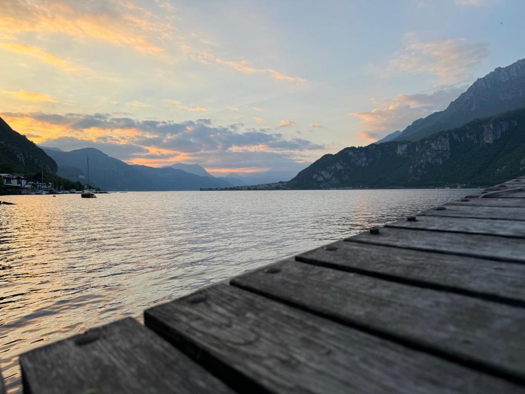 a dock on a lake with mountains in the background at Al Piccolo Pontile Como lake in Mandello del Lario