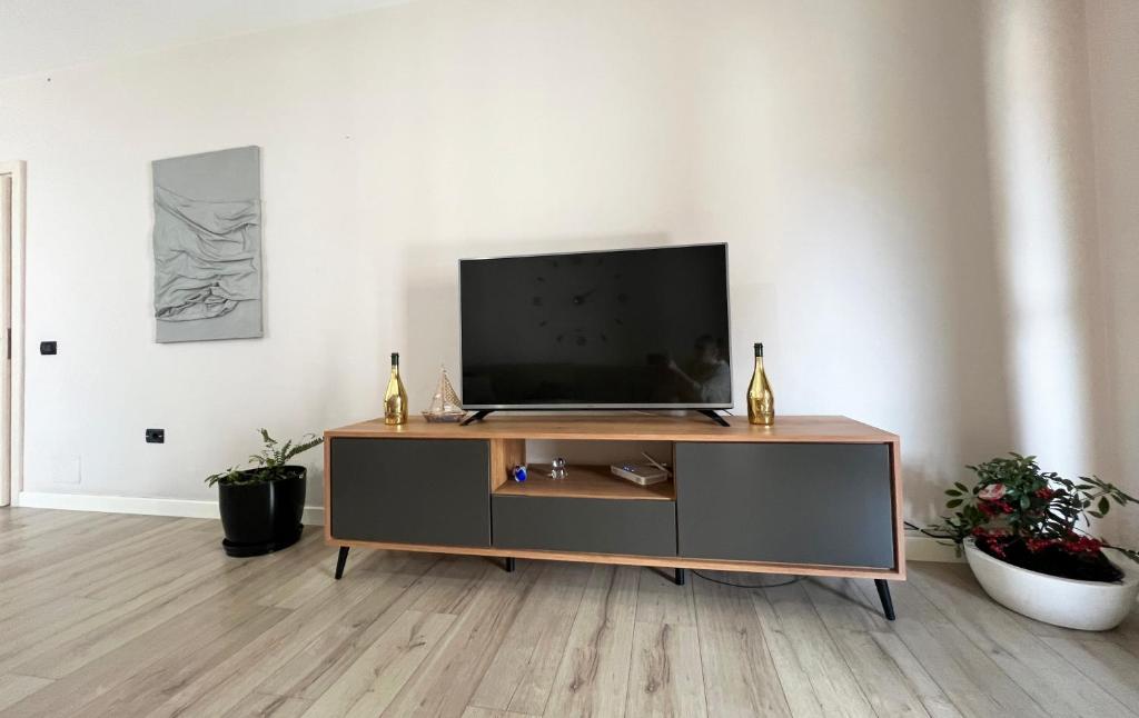 a living room with a flat screen tv on a cabinet at B2 Apartment in Tirana