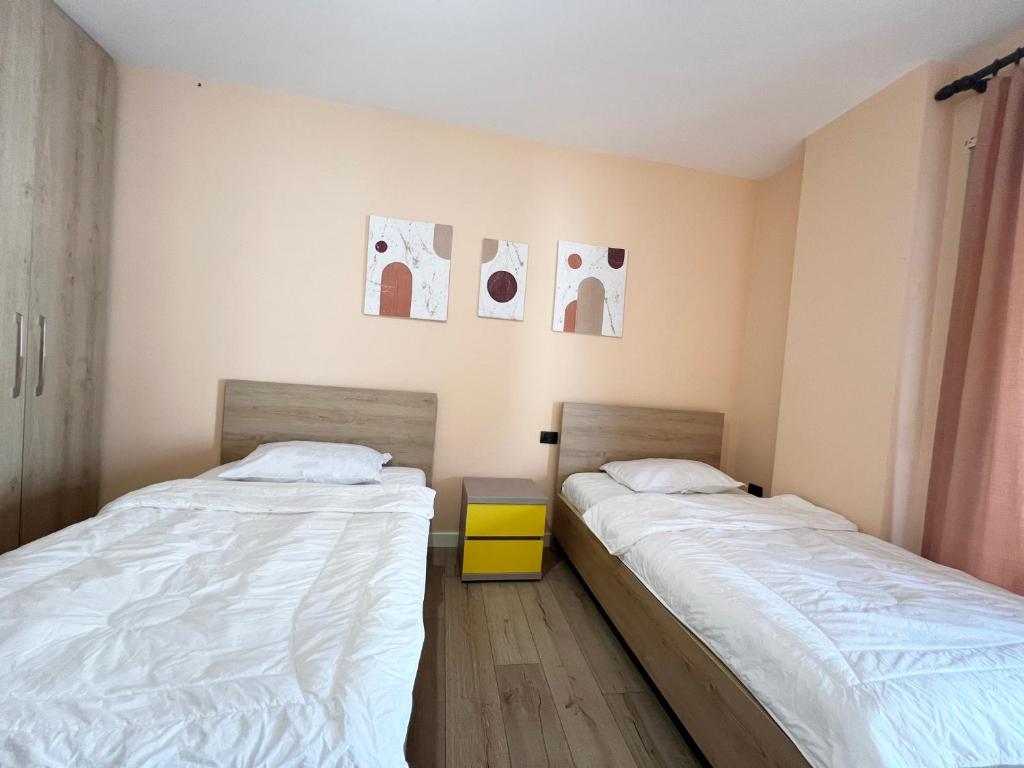 two beds sitting next to each other in a room at B2 Apartment in Tirana